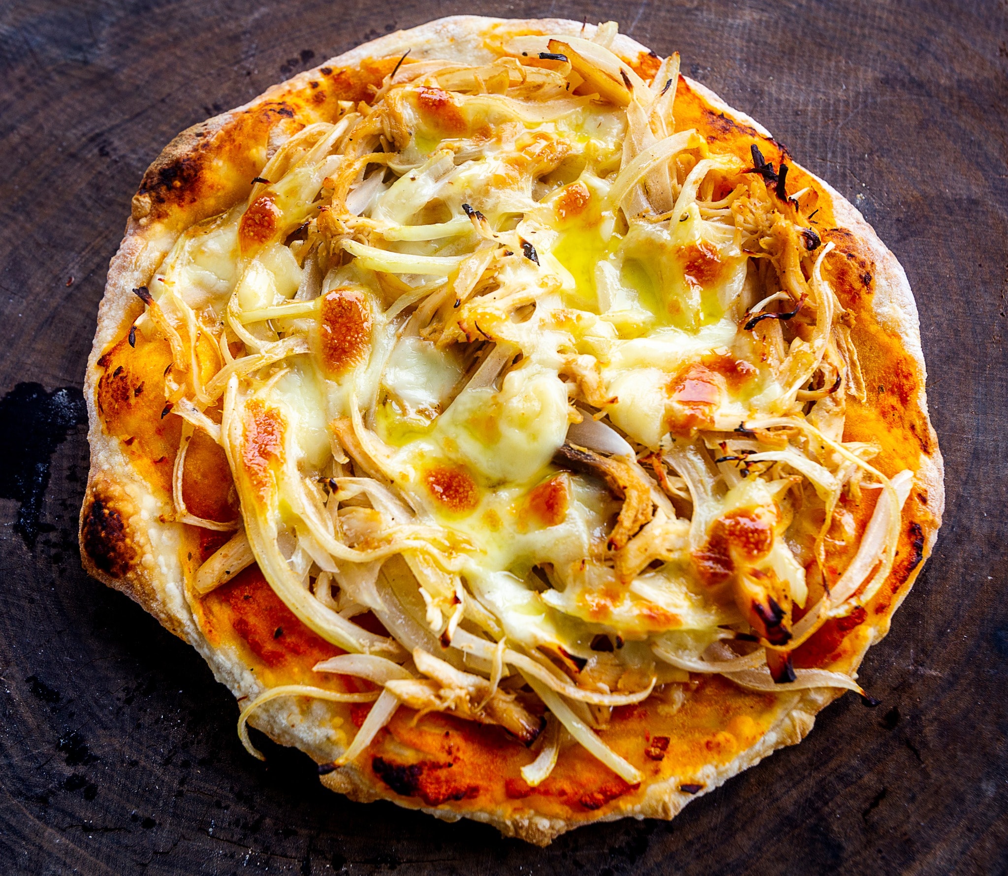 The pizza at Dingo Deli features a golden crispy base topped with fresh ingredients and rich cheese